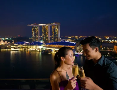 Romantic Singapore honeymoon couple at Marina Bay Sands skyline during sunset tour